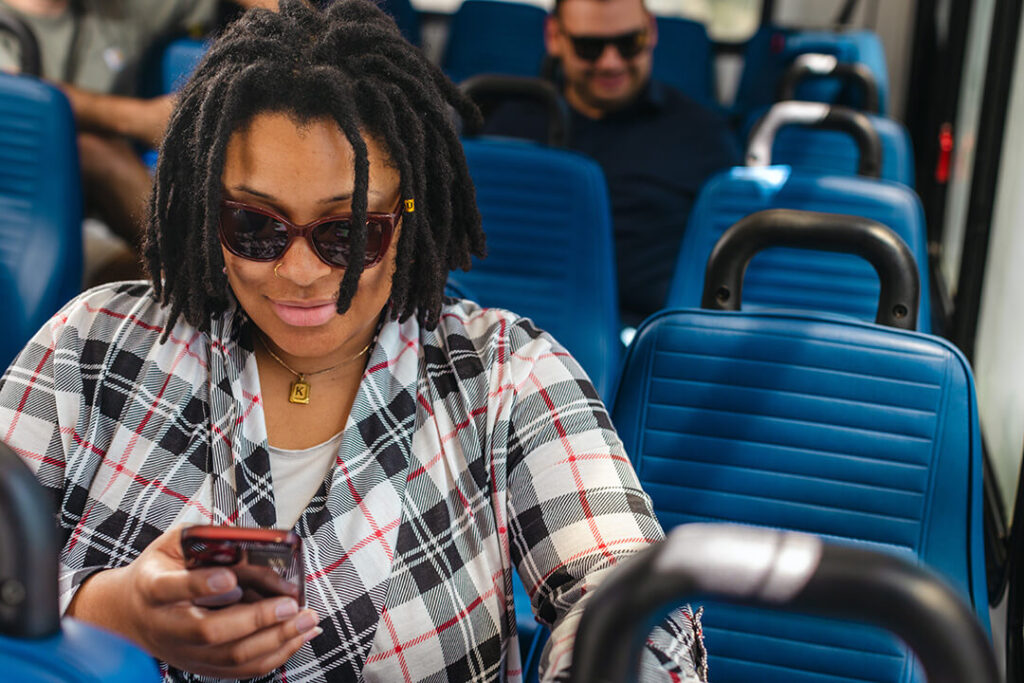 woman riding looking at phone